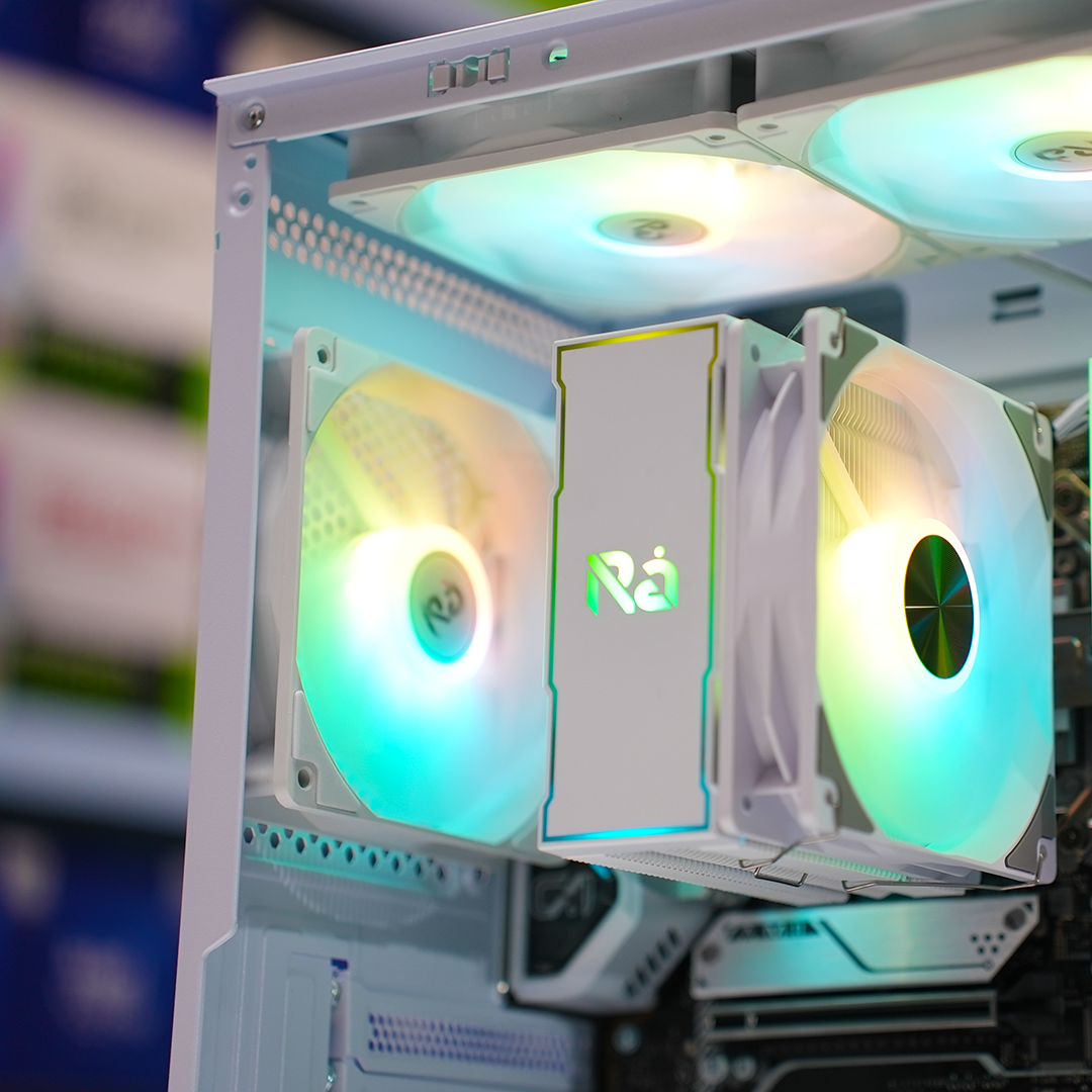 Computer case with RGB lighting and 'RA' branding on a blurred background