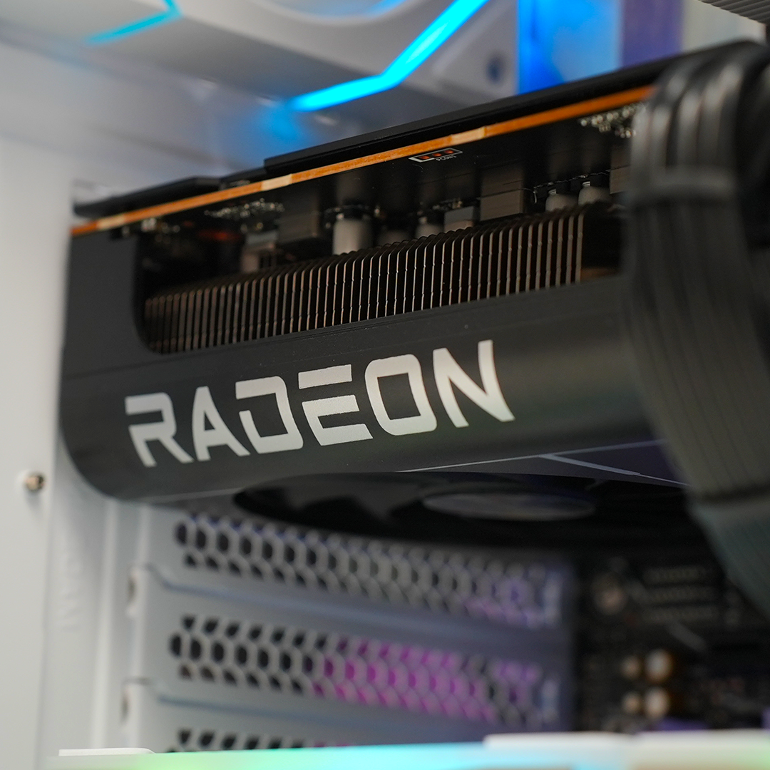 Close-up of Radeon graphics card inside a high-end gaming PC, showcasing advanced cooling and RGB lighting.