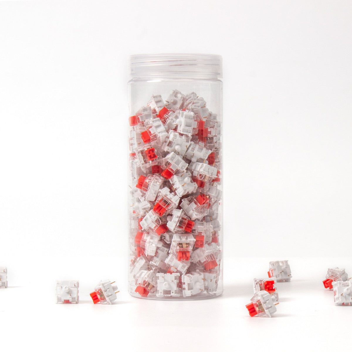 Keychron K Pro Red switches in their bottle, with loose switches