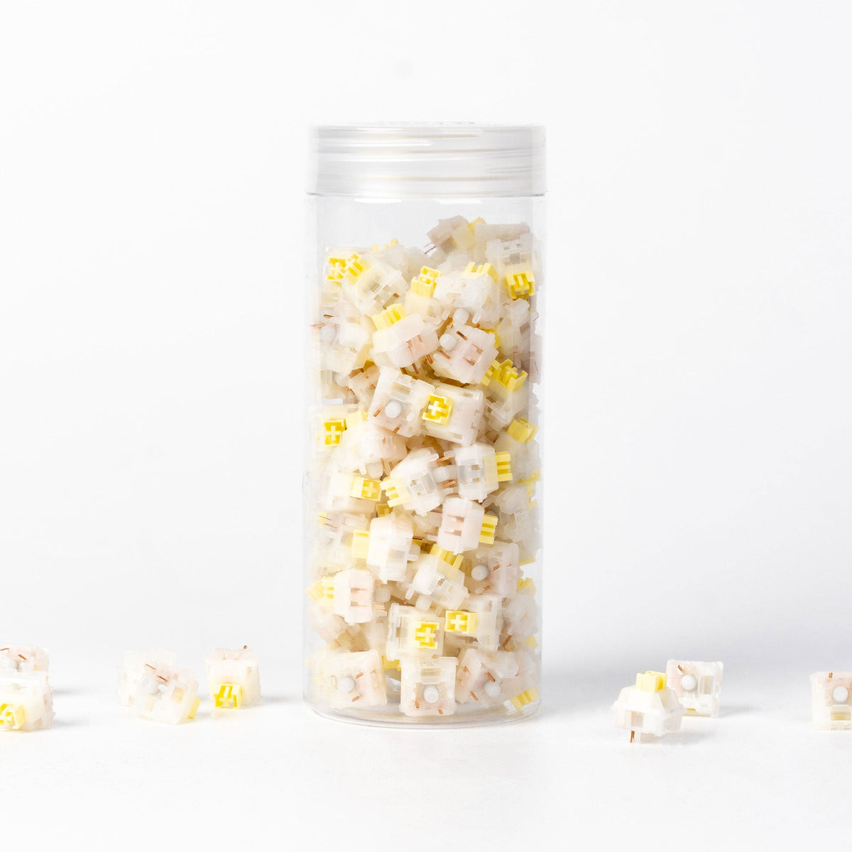 Keychron Silent Banana switches in their bottle, with loose switches