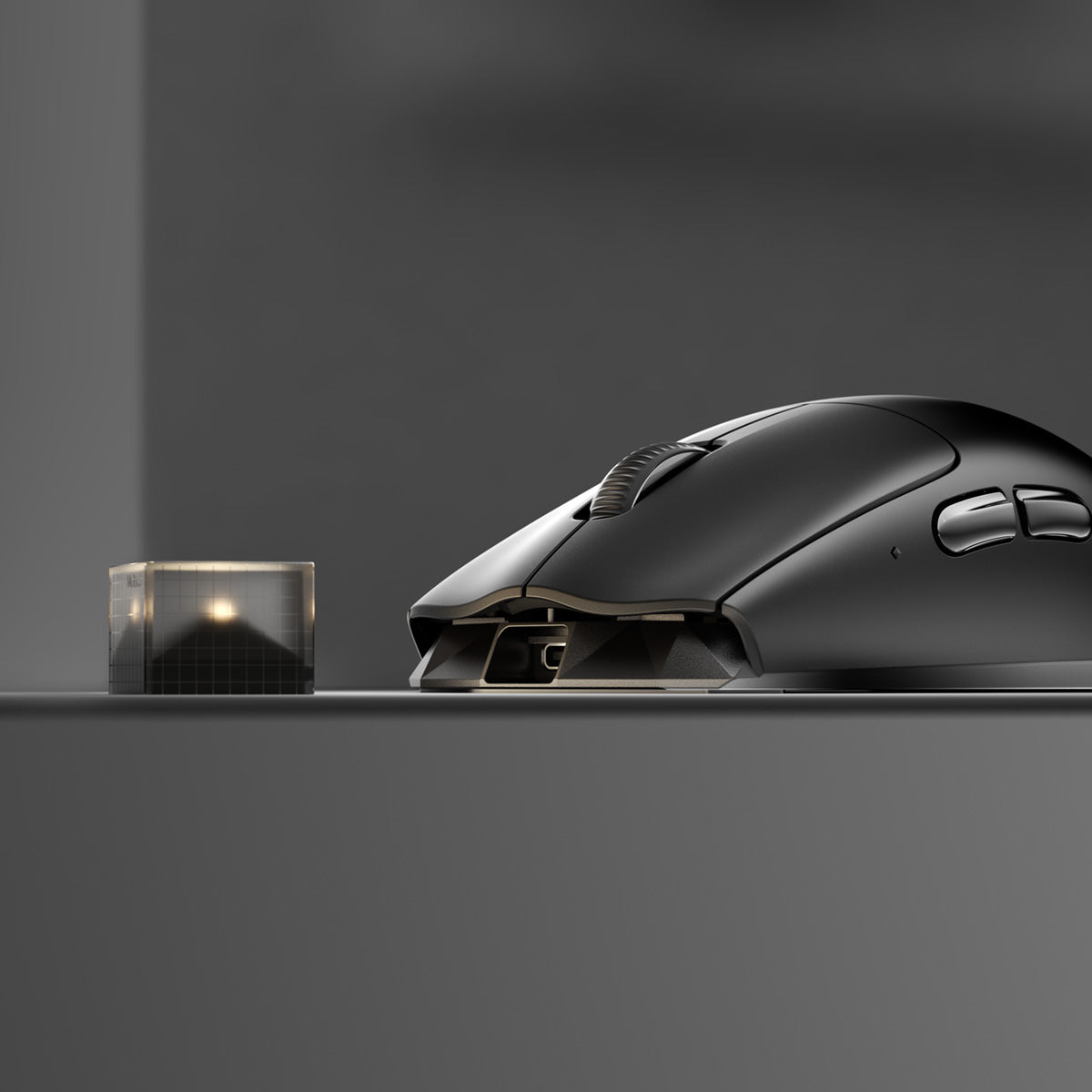 Black MelGeek Horus mouse on a desk next to its receiver