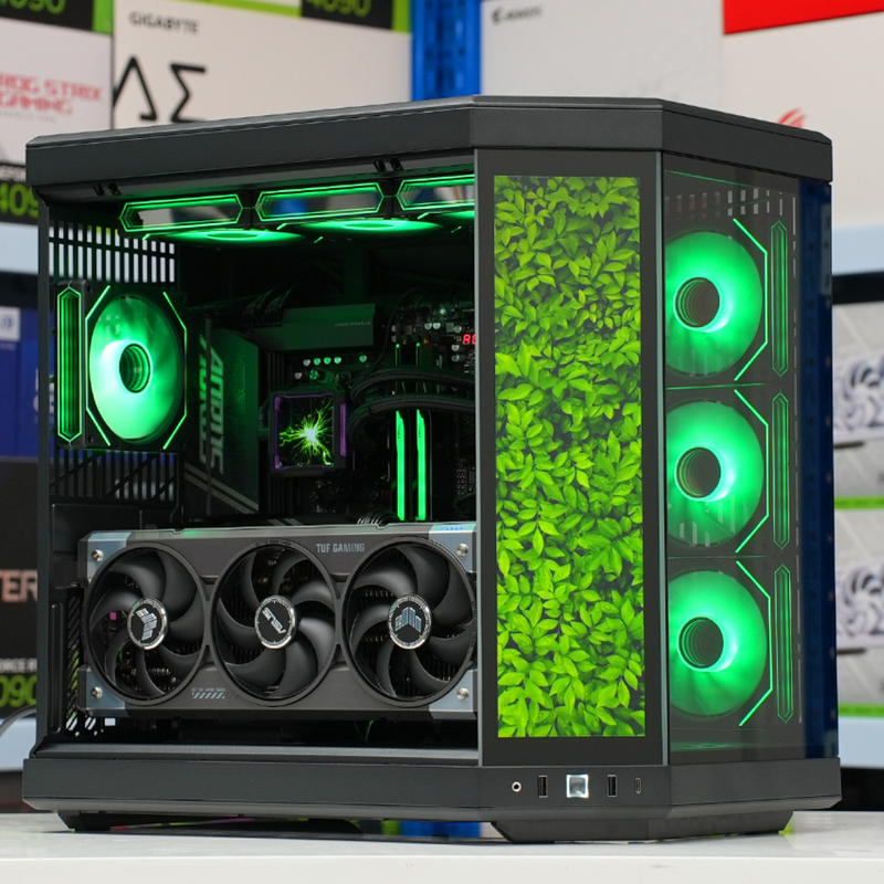 Custom gaming PC with green fans and a living plant wall behind the glass